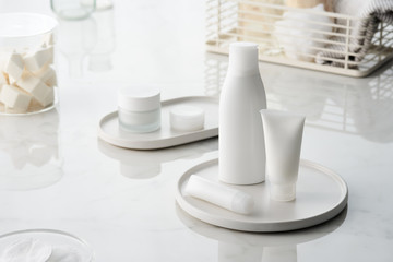 Set of skincare products on bath table