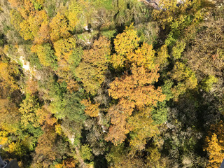 Russia, Sochi best holidays. Beautiful view of the hills, mountains covered with autumn forest, blue river, shadow of the bridge. the view from the top.  