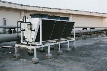 Air compressor on the Building office in city with blue sky background.
