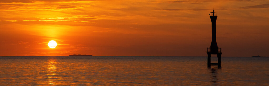 Sihouette Of Light House At The Sea In Sunset