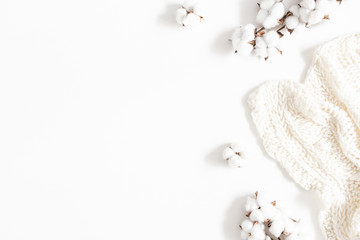 Blanket, cotton flowers on white background. Flat lay, top view, copy space