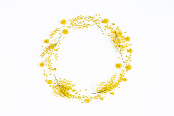 Flowers composition. Wreath made of yellow flowers on white background. Spring concept. Flat lay,...