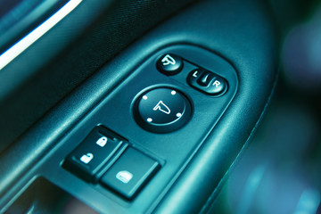 Close-up to mirror adjustent panel in car