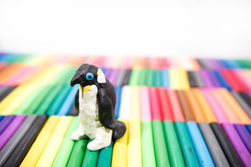Play clay Animals. Penguin on colored background.