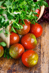 Tomatoes, cooked with herbs for the preservation on the old wooden table.