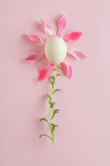 Fototapeta premium creative minimal concept, flower made of pink petals and chicken egg on pastel background, easter card, spring greetings