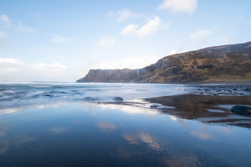 Fototapeta na wymiar Sea cliff waterfall into ocean. Scotland