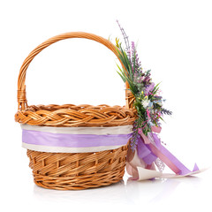 Fototapeta na wymiar Decorative wicker basket with original floral decor and long colored ribbons.