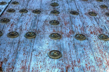 Closeup of an old blue wooden door of a church in Carmona, Seville, Andalusia, Spain.