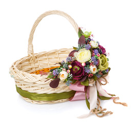 Fototapeta na wymiar Wicker basket with floral decoration. Holiday concept. A beautiful basket for Easter celebration or for a gift.