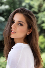 Naklejka premium Woman on a background of nature, greenery.