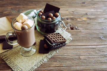 Delicious chocolate smoothie with marshmallows on dark table
