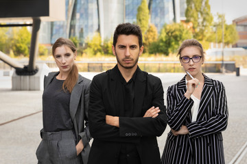 Business partners on the background of an office building. They are confident in themselves and their success in business.