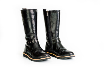 Black leather women’s boots fastened with a zipper. Background for shoes.