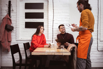 Waiter Takes Order From a young Couple	