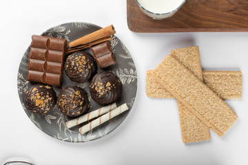Chocolate cookies in a black platter and waffles