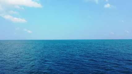Peaceful Pacific ocean and bright blue sky with white clouds, background - Powered by Adobe