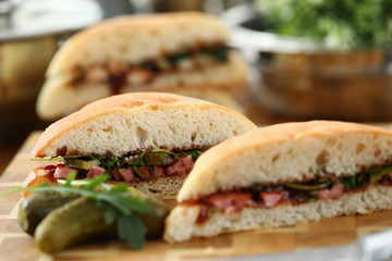 Cut delicious sandwich with ketchup against kitchen closeup background.