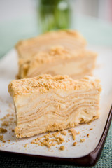 Piece of napoleon cake. Classic layered russian cake.  French mille feuille with whipped sour cream. 