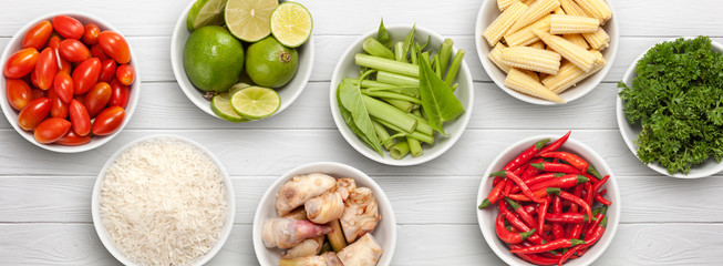 varieties of ingredients in bowls on white wooden background