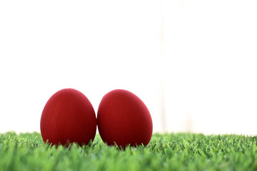 red easter egg on lawn green grass artificial with blank white background