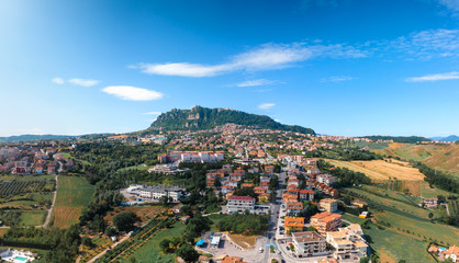 Aerial landscape view from distance on main city rock of San Marino Republic in the background. The concept of the best places for tourism and journey. Down town, Italy