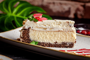 American cuisine. Cheesecake cake with mascarpone cheese and almonds. Serving dishes in a restaurant on a white plate with tea. background image, copy space text