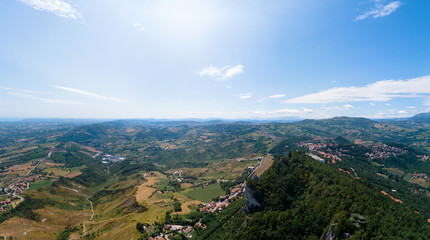 Obraz premium Aerial view on Third, distant tower on top of the mountain. Fortifications, in the background mountains and the city. The concept of wide panorama wallpaper Europe. San Marino, Italy