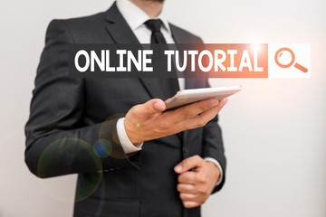Text sign showing Online Tutorial. Business photo text process of tutoring in an online or virtual environment Male human wear formal work suit hold smart hi tech smartphone use one hand