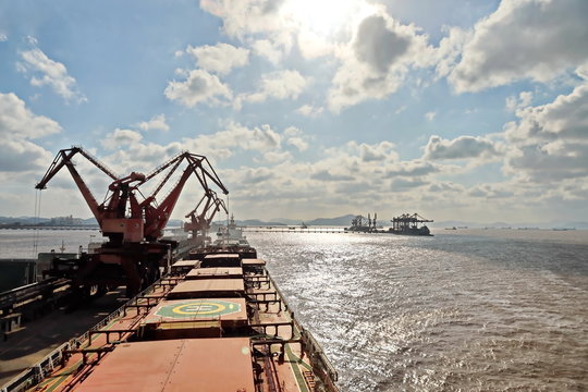 Cargo terminal for unloading grain cargo by shore cranes. Port Zhoushan, China. November, 2019.