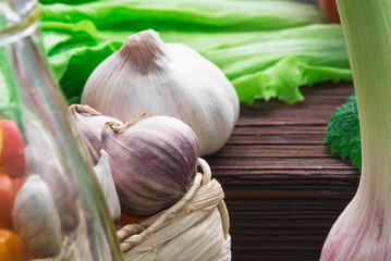 fresh garlic with salad on wooden cutting board