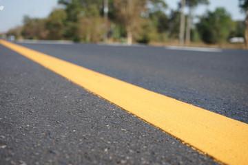 Obraz premium Yellow line color on the road surface