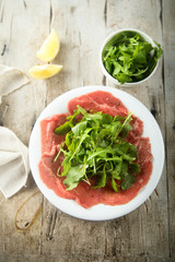 Beef carpaccio with fresh arugula salad