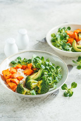 Vegan lunch bowl with rice, broccoli, sweet potato, rice and salad. Vegan food concept.