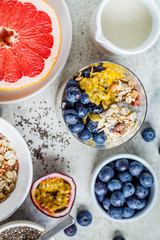 Chia pudding with blueberries, passion fruit and granola in glass, top view. Healthy breakfast concept.