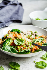 Lentil vegan stew with mushrooms, quinoa, spinach and broccoli in a bowl. Healthy vegan food concept.