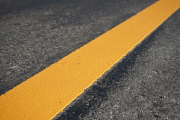 Fototapeta premium Yellow line color on the road surface