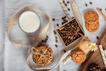 Obraz na płótnie Canvas A glass of milk with oatmeal cookies around. top view