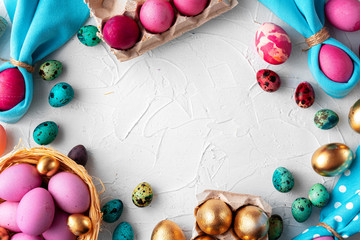 Brightly painted Easter eggs composition on white embossed background