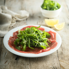 Beef carpaccio with fresh arugula salad