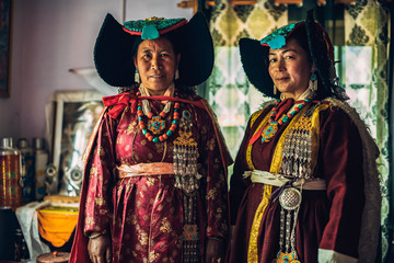 Portrait of women in traditional tibetan clothes inside their house in Ladakh, Kashmir, India - 325677143