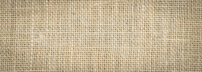 Rough hessian background with flecks of varying colors of beige and brown. with copy space. office desk concept, Hessian sackcloth burlap woven texture background.