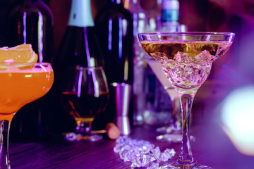 Two beautiful cocktails served on a wooden bar counter