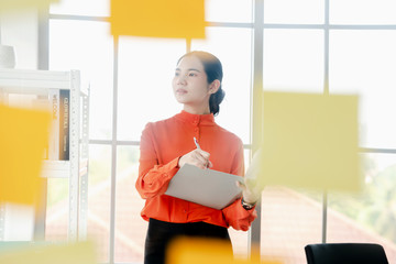 Business woman is reading documents view through window