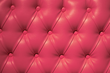 Coach-type velours screed tightened with buttons. Chesterfield style quilted upholstery backdrop close up
