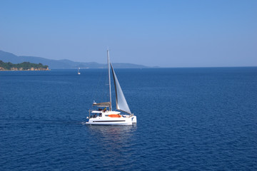  sailboat sails in the mediterranean sea , between the islands of the Aegean Sea