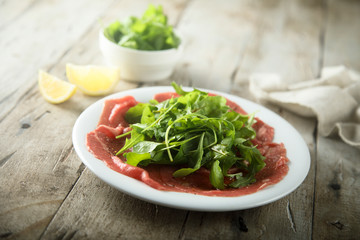 Beef carpaccio with fresh arugula salad