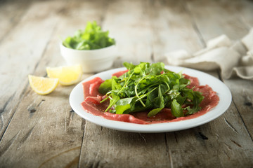 Beef carpaccio with fresh arugula salad
