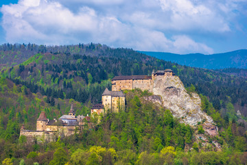 Fototapeta na wymiar orava castle of slovakia. medieval fortress on a hill in a beautiful place in mountains. wonderful sunny weather with fluffy clouds in springtime