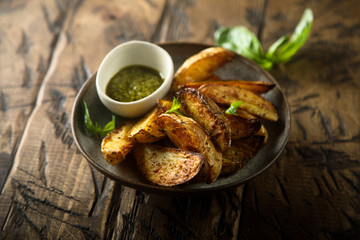 Roasted potato wedges with homemade pesto sauce